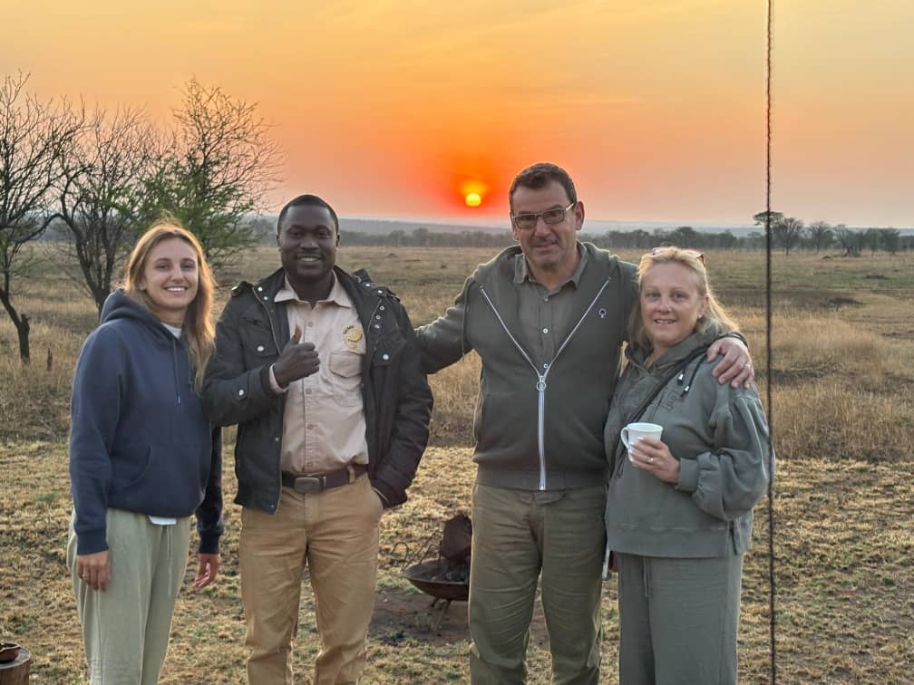 A safari sunset group photo with travellers